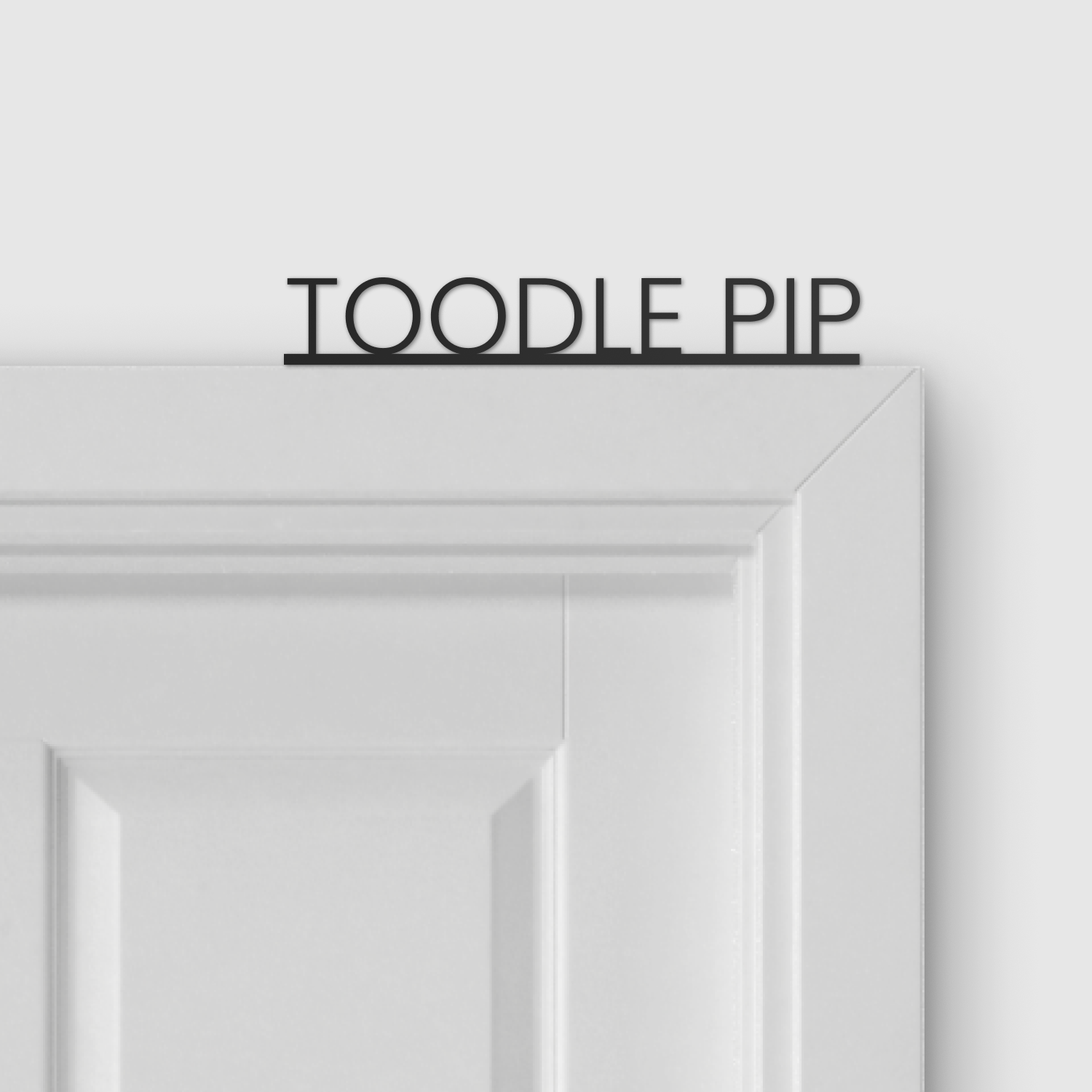Toodle Pip Door Topper displayed above a door
